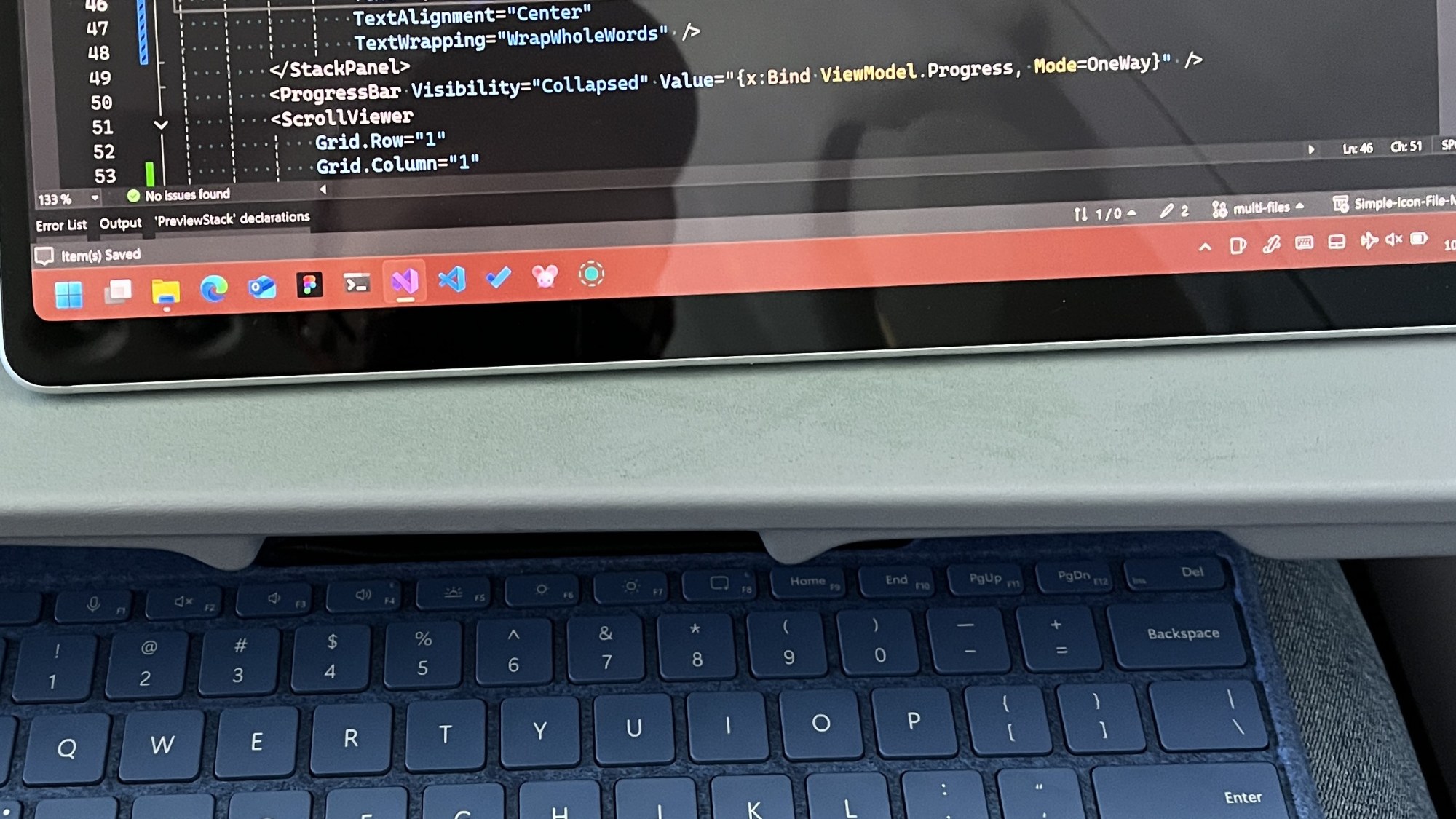 A Surface on a tray table running Visual Studio